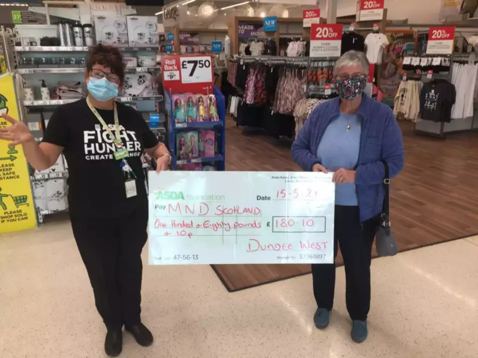 MND Scotland receiving a cheque from a colleague raffle all prizes donated by counter colleague moira . | Asda Dundee West