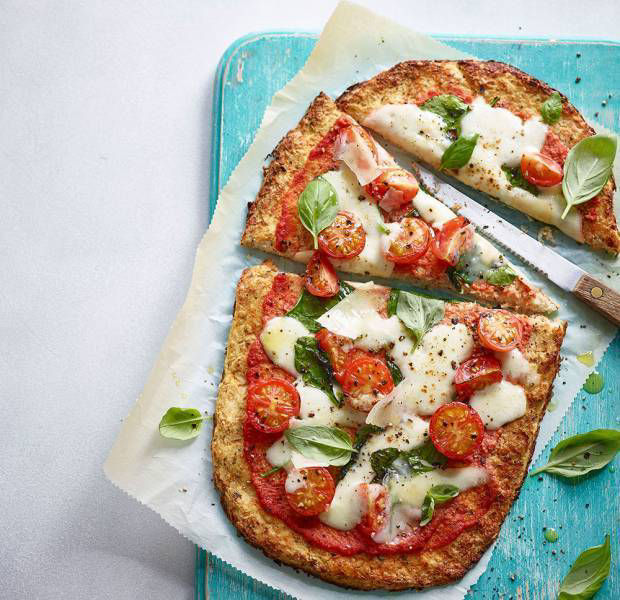 Spinach and cherry tomato cauliflower-base pizza