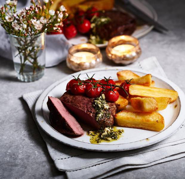Fillet steak with chunky chips, roast tomatoes and pesto