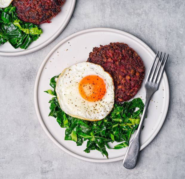 Lentil and beetroot cakes with fried egg and greens