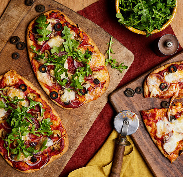 Naan pizzas with mushrooms, olives and red onion