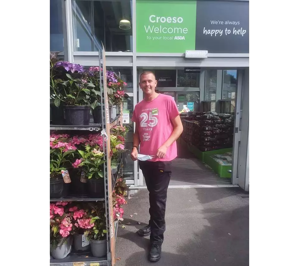 Retained firefighter Neil Shilvock from Asda Pwllheli supports Tickled Pink breast cancer charity campaign