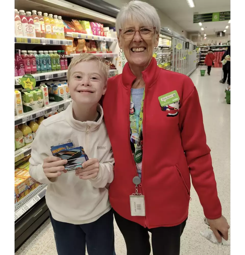 Anne Gaffney from Asda Rossington surprised Logan Roberts with a Christmas gift